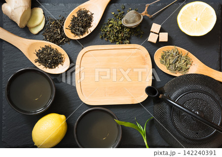 Green japanese and chinese tea with traditional food set on black table. Top view with copy space. 142240391