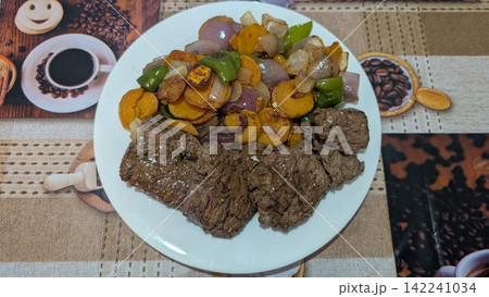 Grilled beef with stir fried vegetables on a white plate Grilled beef with stir fried vegetables on a white plate 142241034