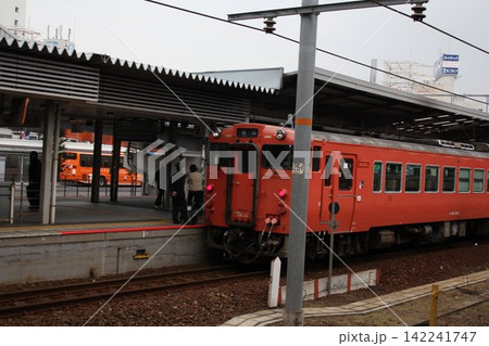 駅のホームに停車する赤いローカル列車 駅のホームに停車する赤いローカル列車 142241747