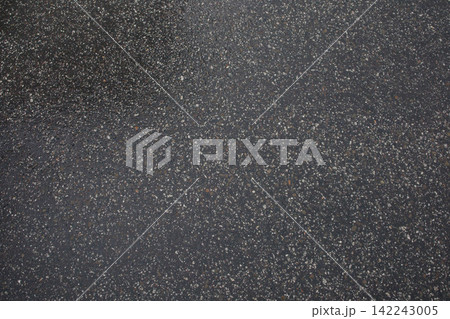 Wet asphalt after the rain close up. Minimalistic background, texture of the road after raining, weather changes. Wet asphalt after the rain close up. Minimalistic background, texture of the road after raining, weather changes. 142243005