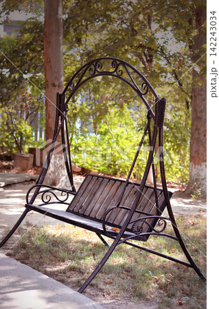 wooden chaise lounge in the park 142243034