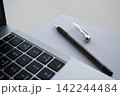 A pen and a laptop close-up. Business and finance concept 142244484