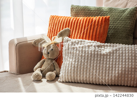 Cozy Home Scene With Plush Pillows And Adorable Stuffed Bunny For Comfort And Relaxation Ambiance 142244830