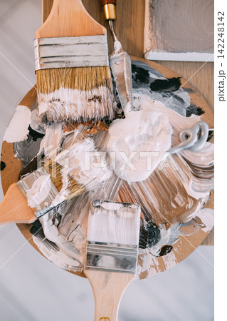 Paint palette. Art supplies. Wooden brushes metal knife ink tools mixing color for professional creative occupation. Paint palette. Art supplies. Wooden brushes metal knife ink tools mixing color for professional creative occupation. 142248142