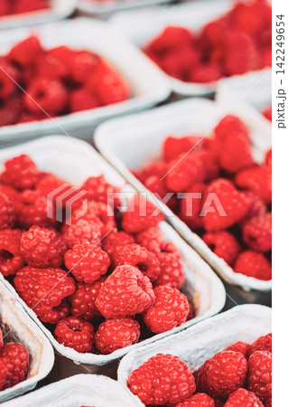 Fresh Raspberries in Baskets at farmers local Market Fresh Raspberries in Baskets at farmers local Market 142249654