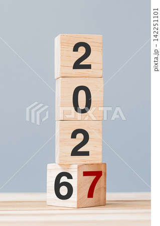 2026 chang to 2027 wooden cube blocks on table background. Resolution, plan, review, goal, start, end year and New Year holiday concepts 2026 chang to 2027 wooden cube blocks on table background. Resolution, plan, review, goal, start, end year and New Year holiday concepts 142251101