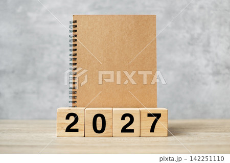2027 Happy New Year with blank notebook and wooden number. countdown, Resolution, Goals, Plan, Action and Mission Concept 142251110