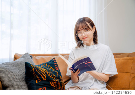 リビングで読書を楽しむ女性 リビングで読書を楽しむ女性 142254650