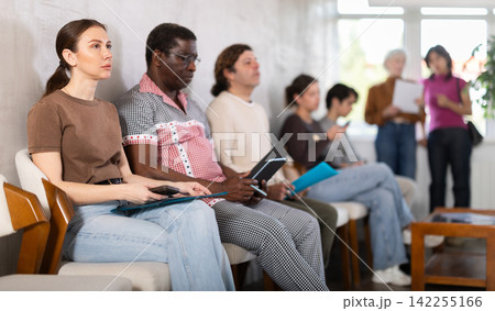 People sitting in line inside a modern office 142255166