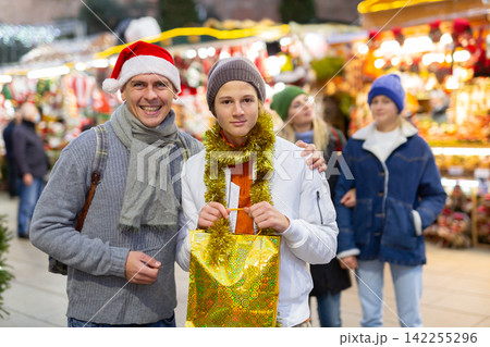 Portrait of happy father with daughter and son at christmas fair 142255296