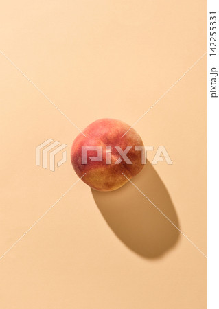 fresh ripe peach fruit on orange background 142255331