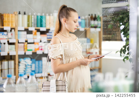 Pregnant woman with prescription in drugstore Pregnant woman with prescription in drugstore 142255455