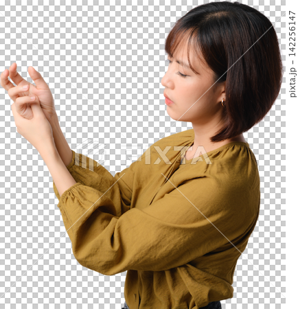 Unhappy asian woman suffering from painful wrist ache and joint stiffness while holding hand isolated on transparent background Unhappy asian woman suffering from painful wrist ache and joint stiffness while holding hand isolated on transparent background 142256147