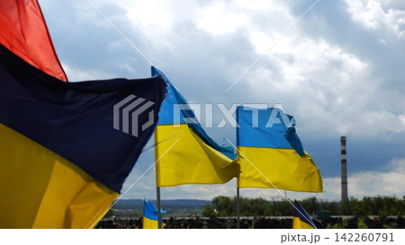 View on blue-yellow flags at countless graves of ukrainian soldiers alley of glory in Kharkiv. This site commemorates heroes and maintains the memory of wartime events in Ukraine. Slow moiton View on blue-yellow flags at countless graves of ukrainian soldiers alley of glory in Kharkiv. This site commemorates heroes and maintains the memory of wartime events in Ukraine. Slow moiton 142260791