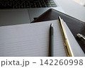Open blank document notebook with pens on laptop background. Business agreement signing, office paperwork and legal contract 142260998
