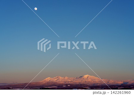 北海道 冬の大雪山連峰と月 夕焼けに染まる雪山の絶景 北海道 冬の大雪山連峰と月 夕焼けに染まる雪山の絶景 142261960