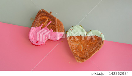 Creative isometric idea Valentine's Day Holiday celebration Heart shaped croissants on two colored background with copy space. Puff pastry new trendy sweet dessert bakery. Creamy dough 142262984