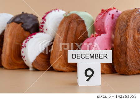 Pastry day 9 December wooden calendar cubes wishes greeting holiday card Heartshaped pastry croissant treat topped with colorful frosting galore. Food experimentation viral dessert baking trend Pastry day 9 December wooden calendar cubes wishes greeting holiday card Heartshaped pastry croissant treat topped with colorful frosting galore. Food experimentation viral dessert baking trend 142263055