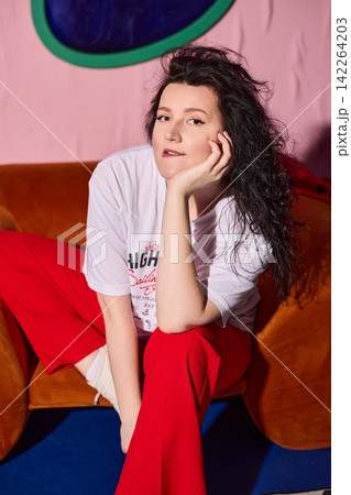 Smiling lady in colorful studio setting with cheerful attitude Smiling lady in colorful studio setting with cheerful attitude 142264203