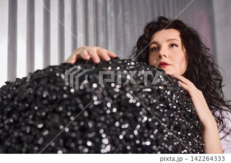 Female artist rehearses under bright spotlight with textured prop Female artist rehearses under bright spotlight with textured prop 142264333