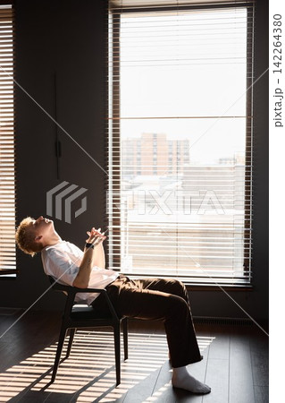Relaxed man with eyes closed observing peaceful cityscape during afternoon Relaxed man with eyes closed observing peaceful cityscape during afternoon 142264380