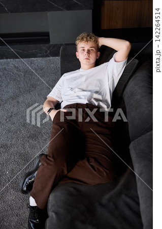 Relaxed college student in cozy room with soft illumination 142264514