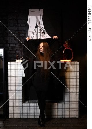 Shadowed character holding secrets in subdued theatrical ambiance Shadowed character holding secrets in subdued theatrical ambiance 142264544