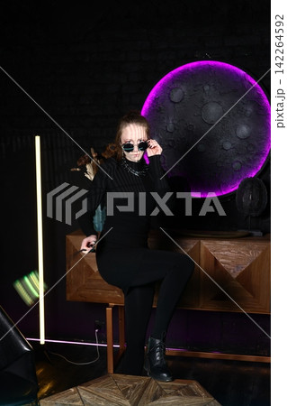 Underground club scene featuring DJ with neon lights and powerful sound 142264592