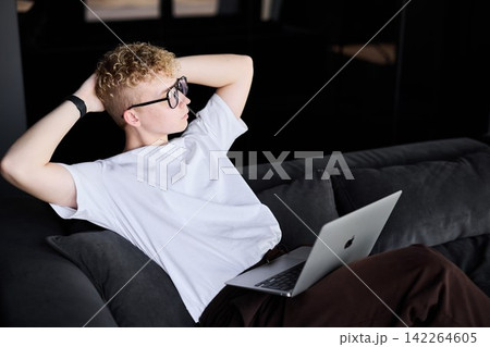 Young caucasian man consultant preparing presentation on couch Young caucasian man consultant preparing presentation on couch 142264605