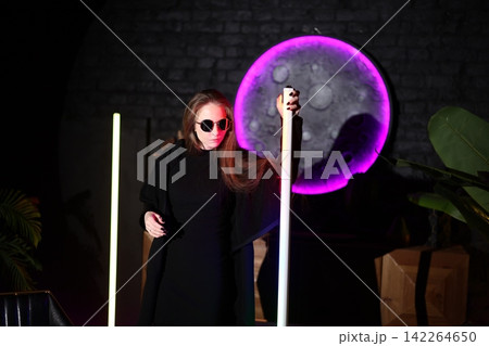 Caucasian interior stylist presenting neon installation Caucasian interior stylist presenting neon installation 142264650