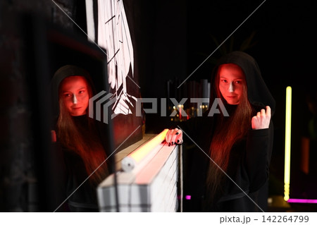 Caucasian female seer in vibrant neon glow with tarot cards Caucasian female seer in vibrant neon glow with tarot cards 142264799
