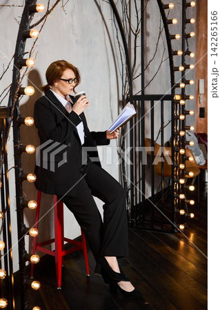 Woman prepares her speech confidently under decorative lighting 142265166
