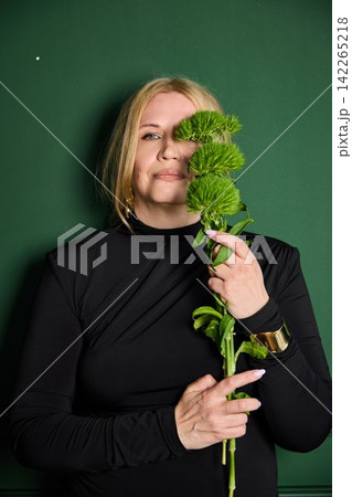 White woman playful candid portrait with chrysanthemum 142265218