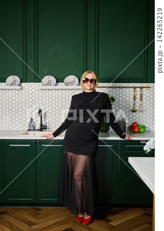 Refined woman in modern kitchen with upscale workspace vibe Refined woman in modern kitchen with upscale workspace vibe 142265219