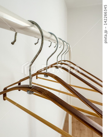Bamboo Hangers on White Clothes Rack, Hook Detail Close-Up 142266345