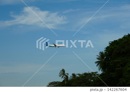 Airplane Flying Over Tropical Island Landscape Photography Airplane Flying Over Tropical Island Landscape Photography 142267604