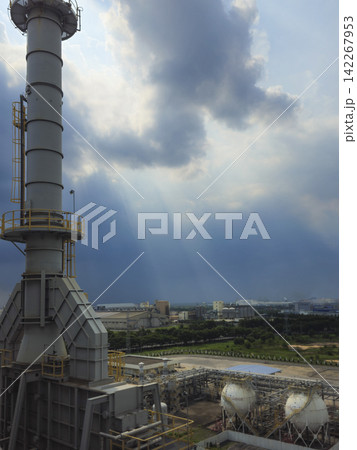 Industrial plant and refinery facilities under dramatic sky with crepuscular rays. Industrial plant and refinery facilities under dramatic sky with crepuscular rays. 142267953