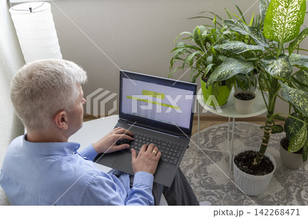 Senior Businessman Reviewing Mortgage Amortization Table on Laptop While Relaxing at Home Senior Businessman Reviewing Mortgage Amortization Table on Laptop While Relaxing at Home 142268471