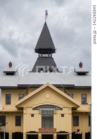A magnificent architectural masterpiece stands proudly under a dramatic, overcast sky, showcasing a harmonious blend of traditional heritage and academic prestige. The building features an elegant 142268845