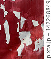 Peeling Red and White Paint Texture on Weathered Wall 142268849