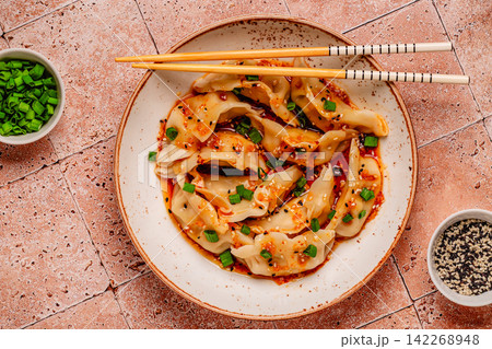 Dumplings with spicy sauce served on a plate Dumplings with spicy sauce served on a plate 142268948