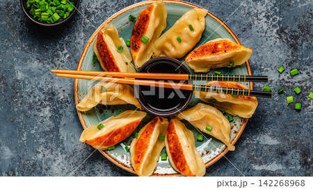 Dumplings served on a plate with green onions Dumplings served on a plate with green onions 142268968