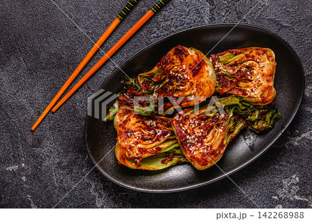 Cooked cabbage bok choy served on a plate with spices. Cooked cabbage bok choy served on a plate with spices. 142268988