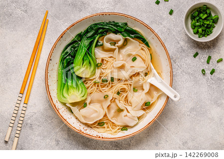 Warm noodle soup with dumplings (wontons) and cabbage bok choy Warm noodle soup with dumplings (wontons) and cabbage bok choy 142269008