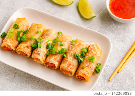 Fried spring rolls served with lime and sauce Fried spring rolls served with lime and sauce 142269058