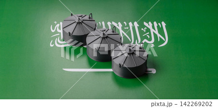 Liquefied gas storage tanks set against the Saudi Arabian flag, concept of supply and distribution Liquefied gas storage tanks set against the Saudi Arabian flag, concept of supply and distribution 142269202