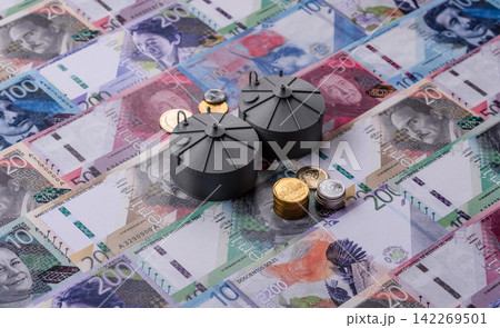 Liquefied gas storage tanks set against the Peruvian money as a background for your design 142269501
