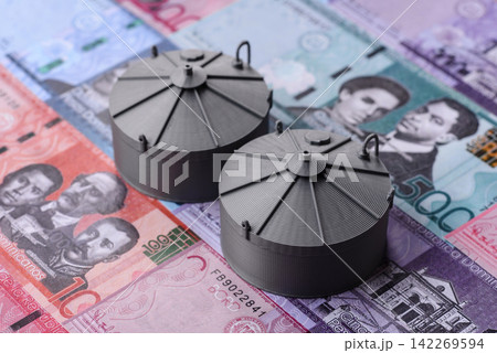 Liquefied gas storage tanks set against the Dominican money as a background for your design Liquefied gas storage tanks set against the Dominican money as a background for your design 142269594