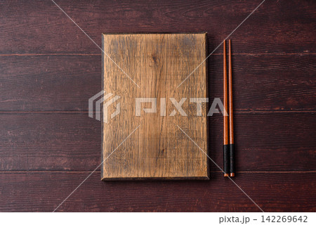 A square wooden cutting board for home food preparation. A wooden cutting board A square wooden cutting board for home food preparation. A wooden cutting board 142269642