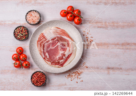 Slices of pork pancetta, ham, or bacon for a festive antipasto platter 142269644